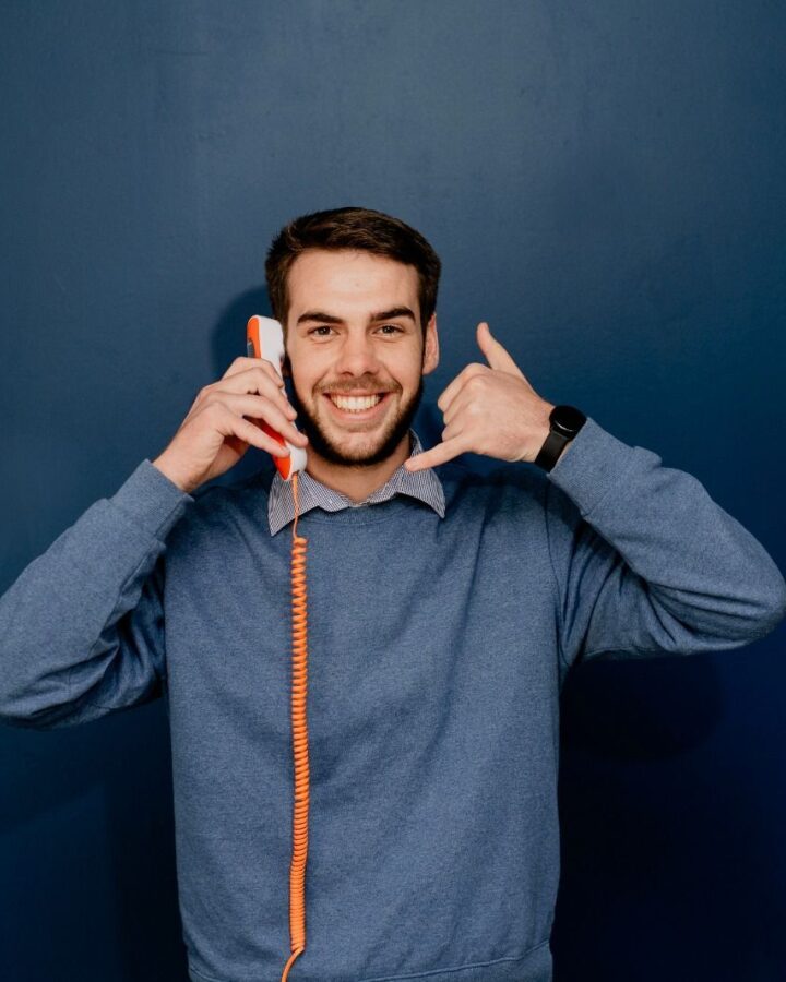 A Nova Life consultant making a call-me gesture