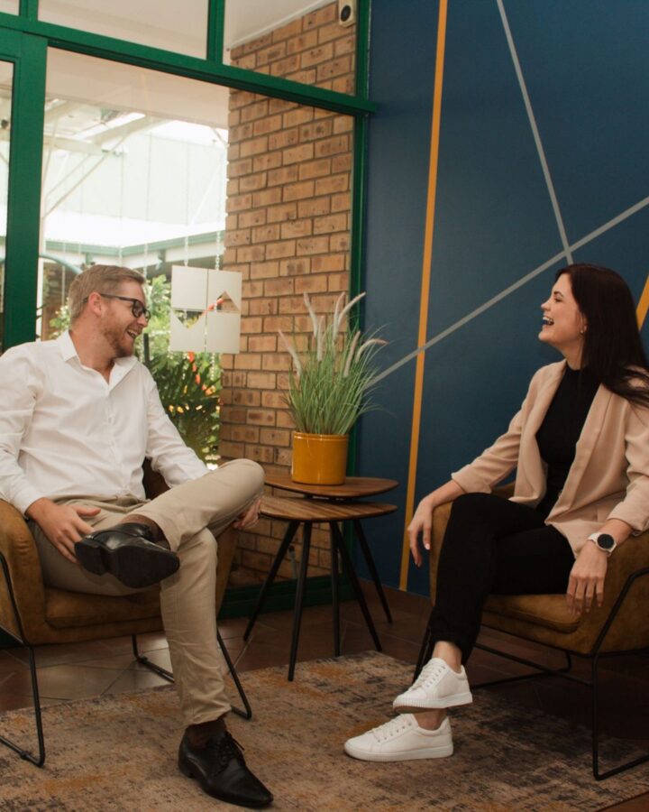 Two Nova Life team members laughing in the office lounge